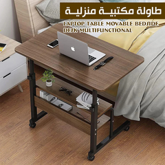 طاولة مكتب كمبيوتر محمول بجوار السرير مع أرفف تخزين